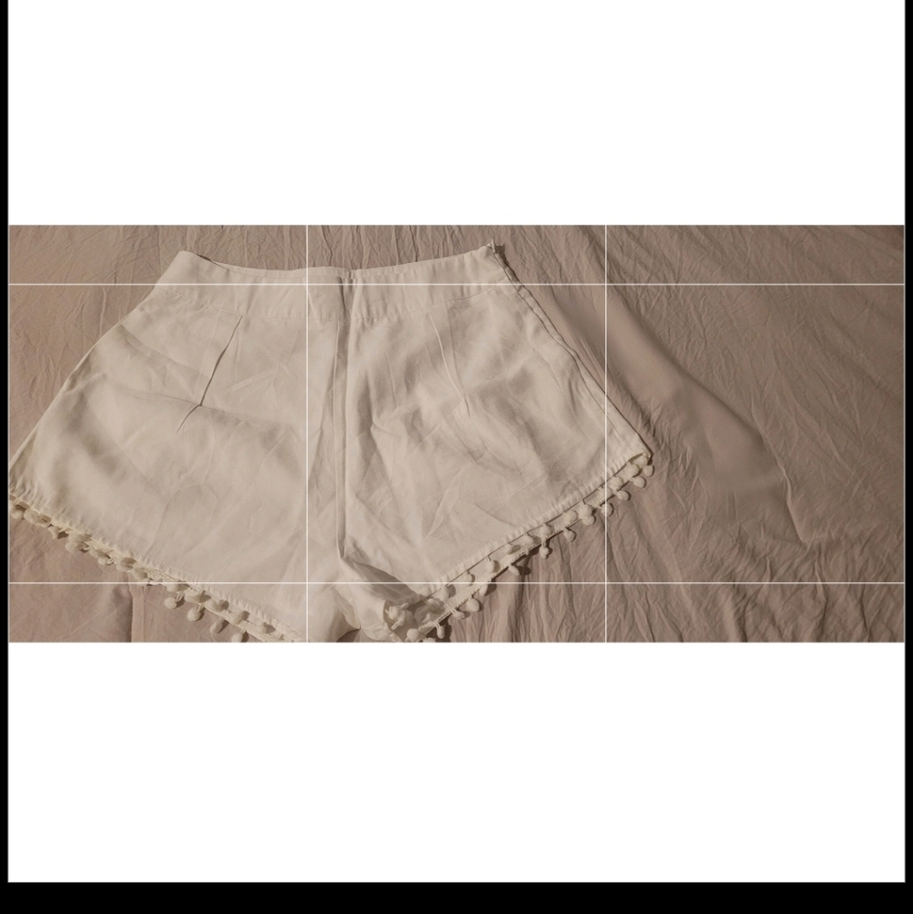 White shorts with ball tassles